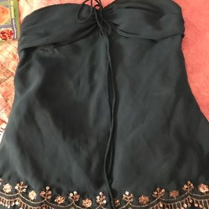 Sleeveless emerald green top.